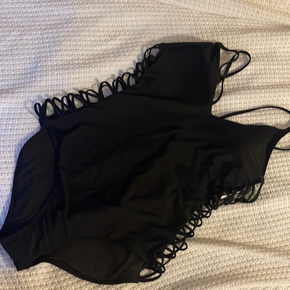 NWOT Black one piece with cut out sides… never worn.  Tags have been removed